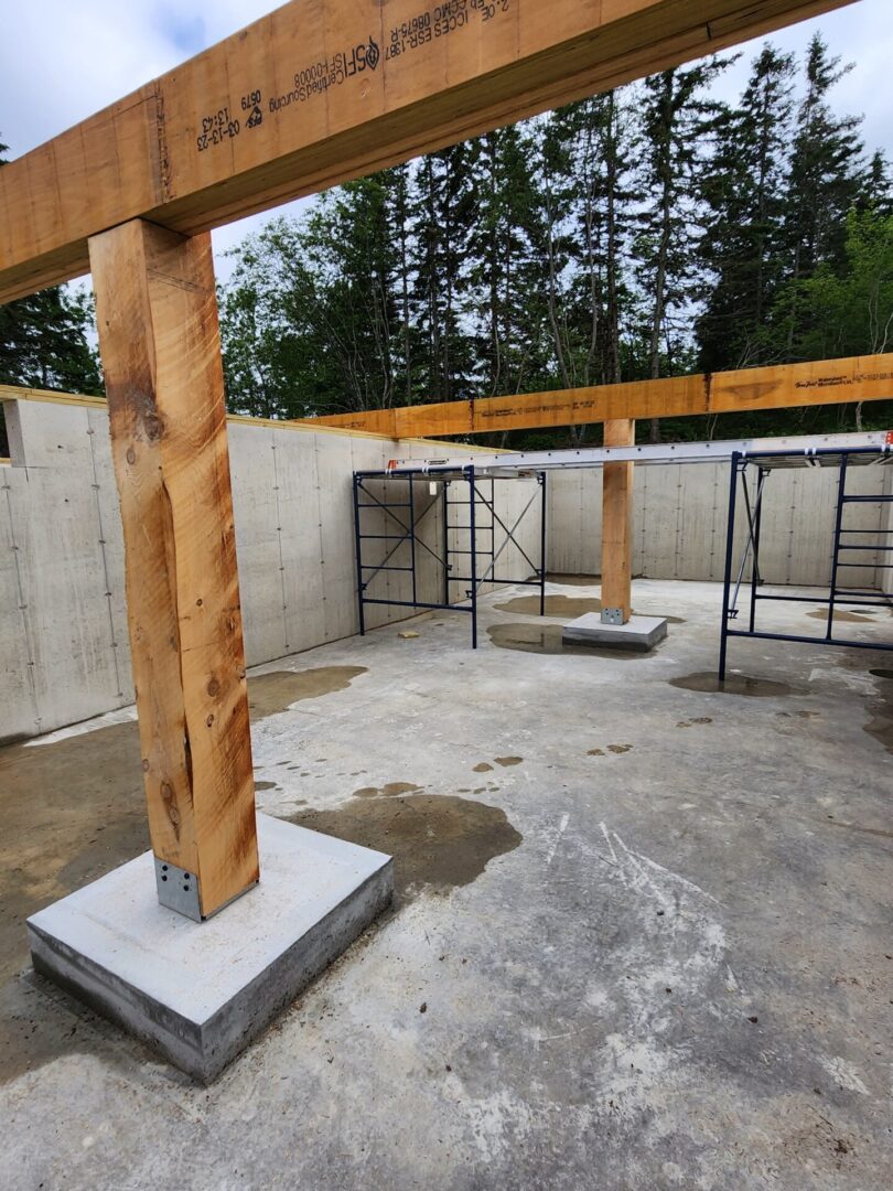 A concrete slab with wooden posts and a beam.