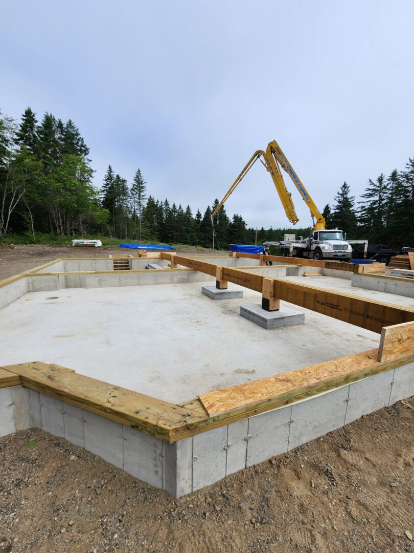 A concrete slab being poured for the foundation of a house.