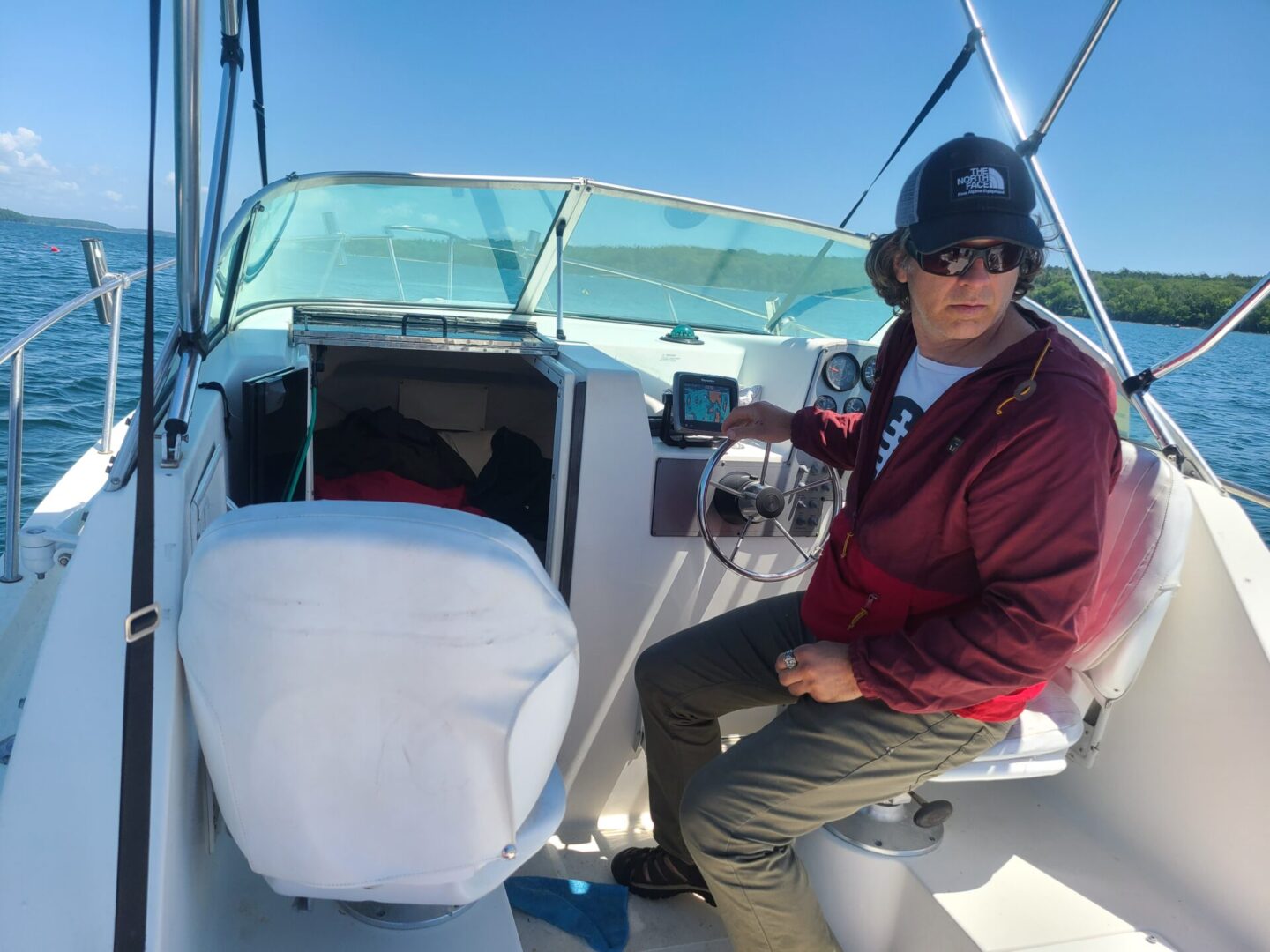 A man sitting on the back of a boat.