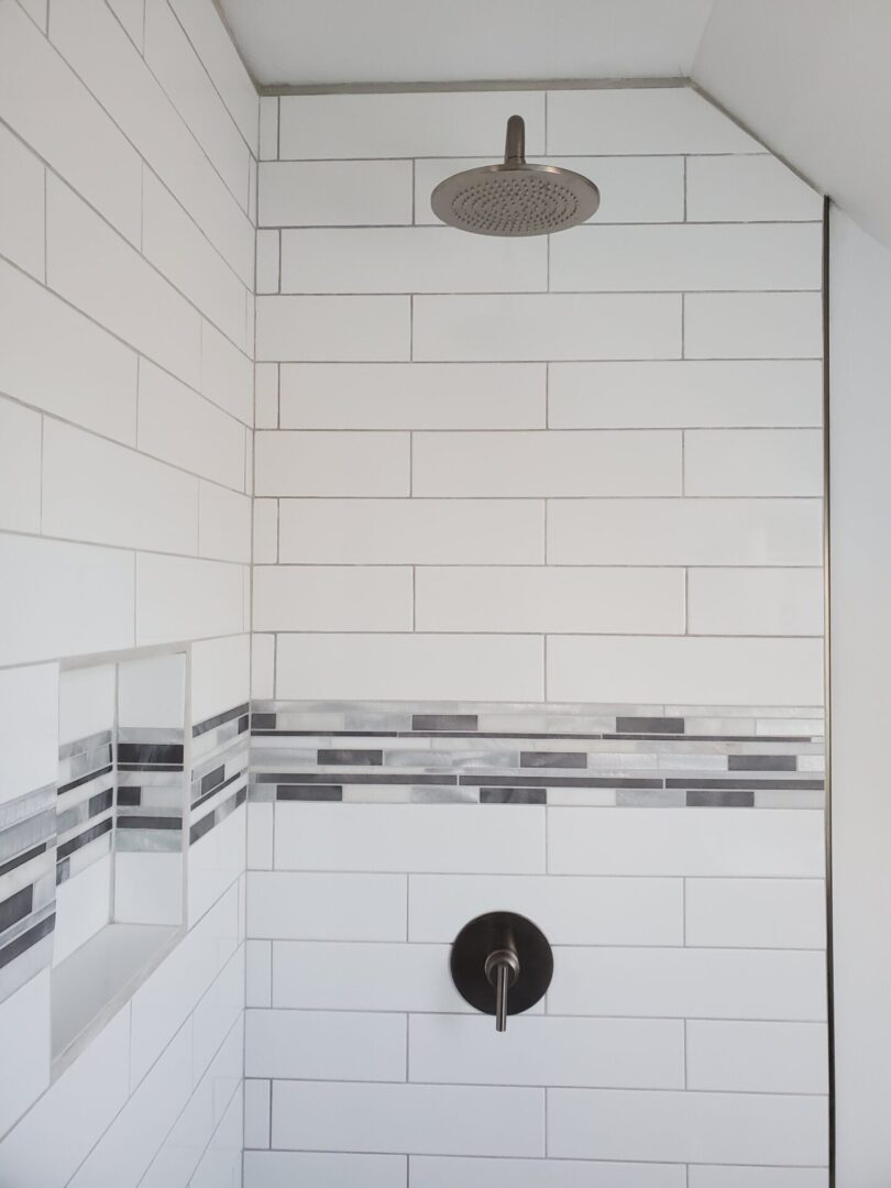 A shower with tiled walls and floor