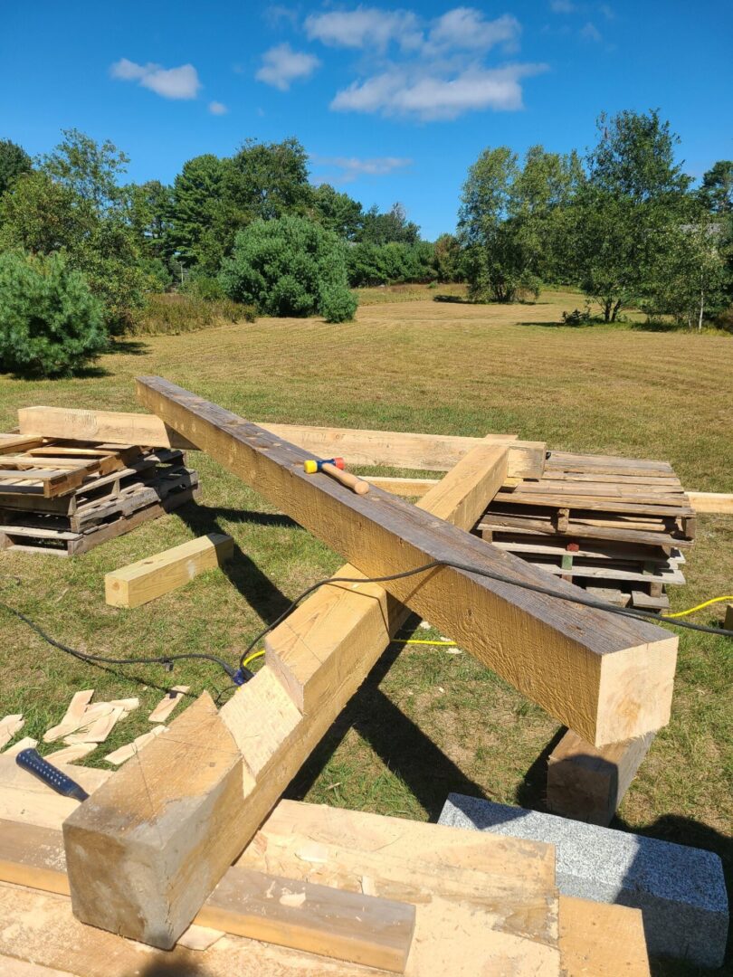 A wooden beam sitting in the middle of a field.