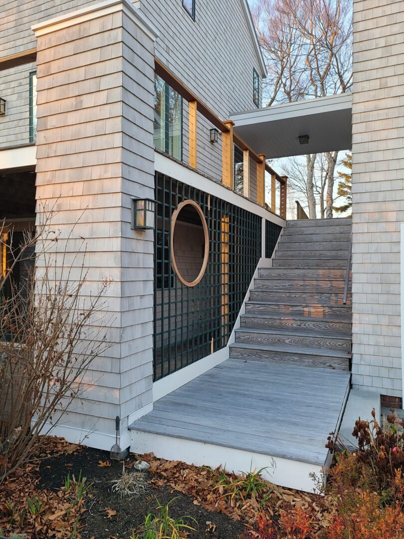 A building with stairs leading to the front door.