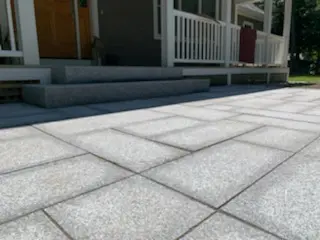 A close up of the sidewalk outside of a house