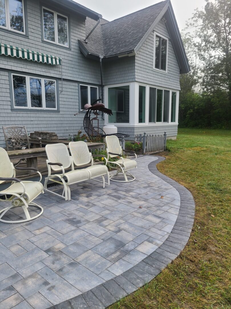 A patio with chairs and a lawn chair.