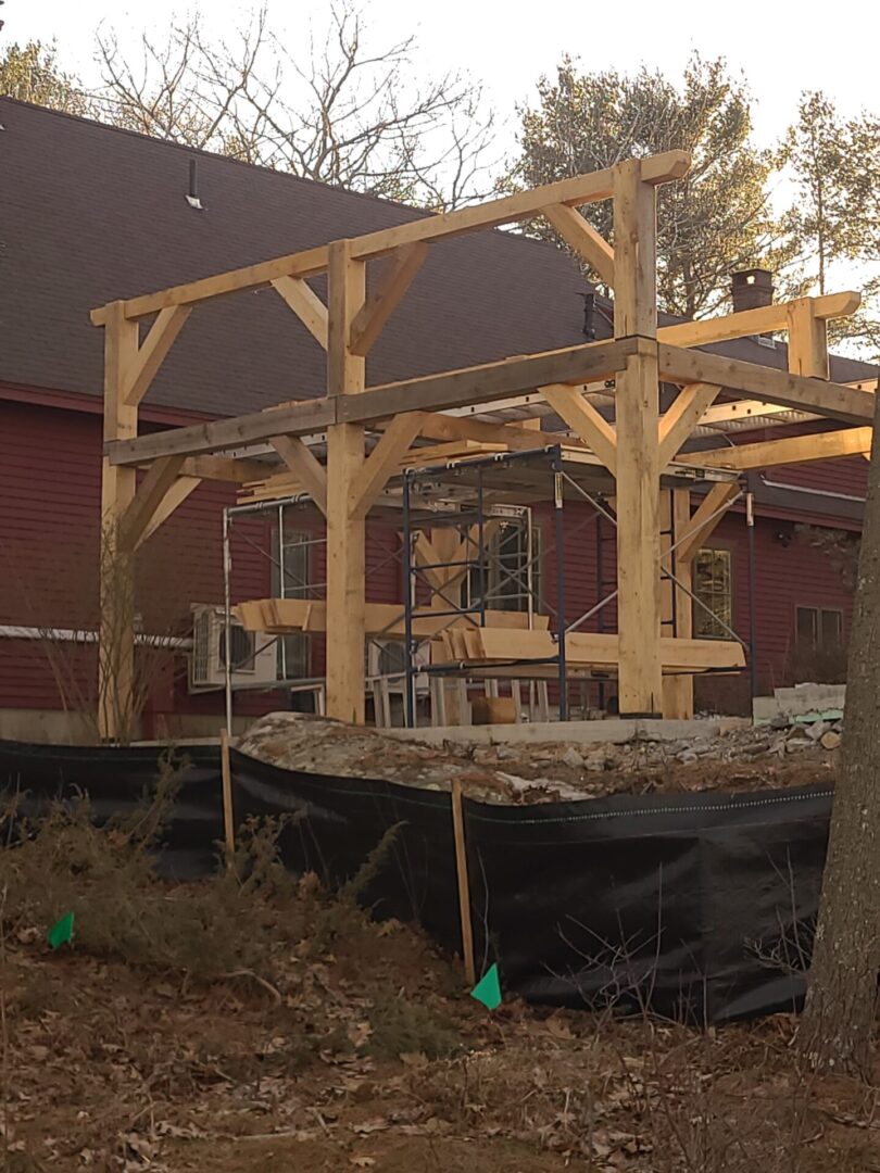 A wooden structure being built in the yard.