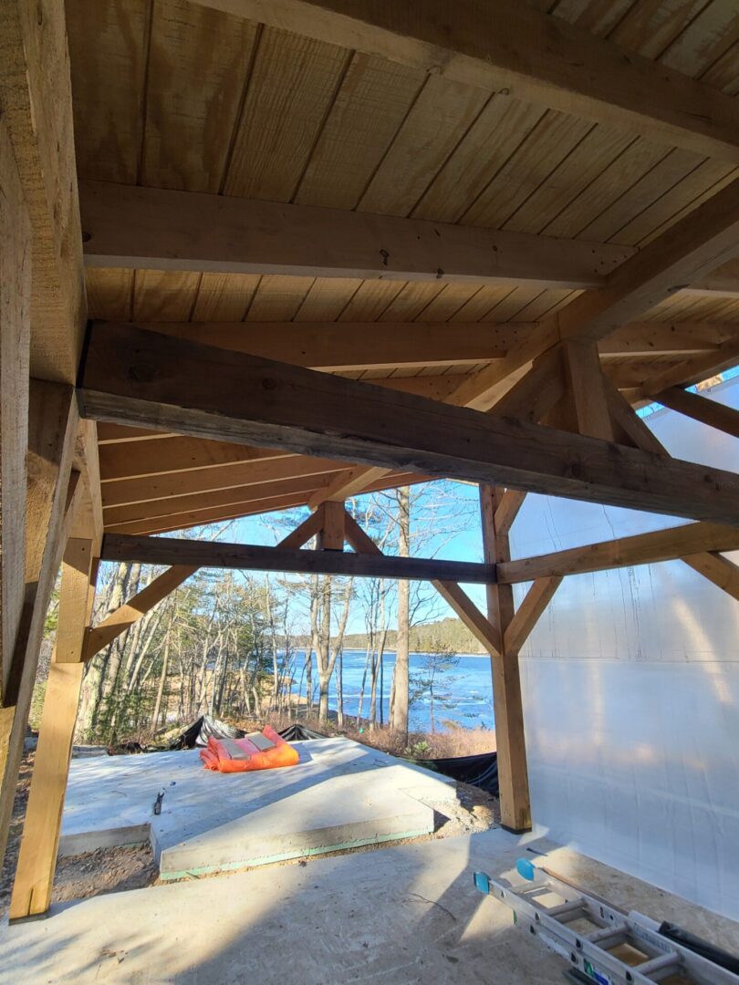 A wooden structure with a lake in the background.