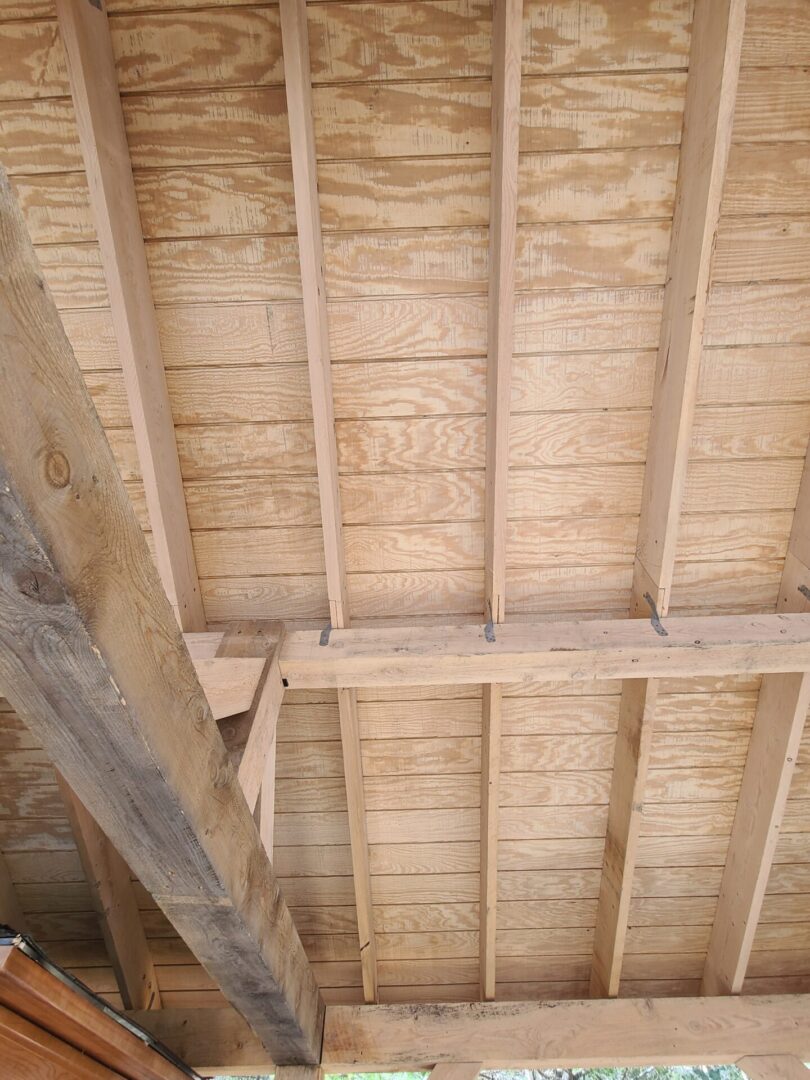 A wooden ceiling with exposed rafters and beams.