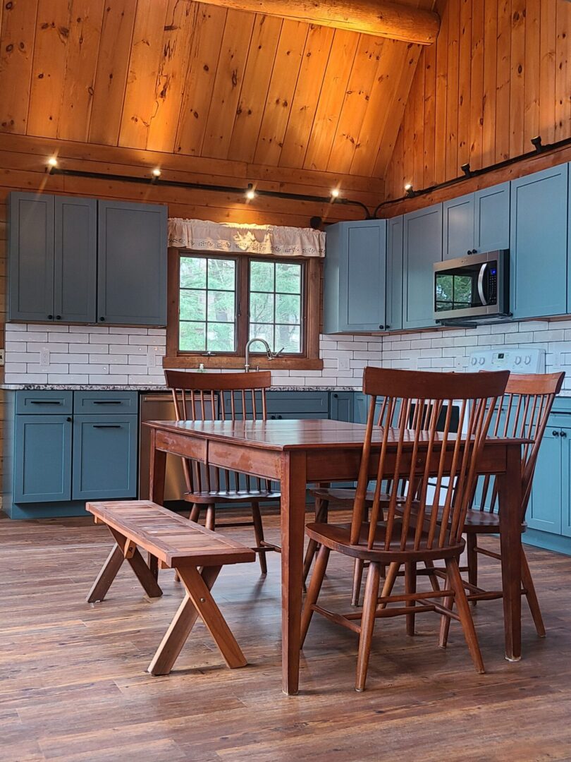 A kitchen with blue cabinets and wooden furniture.