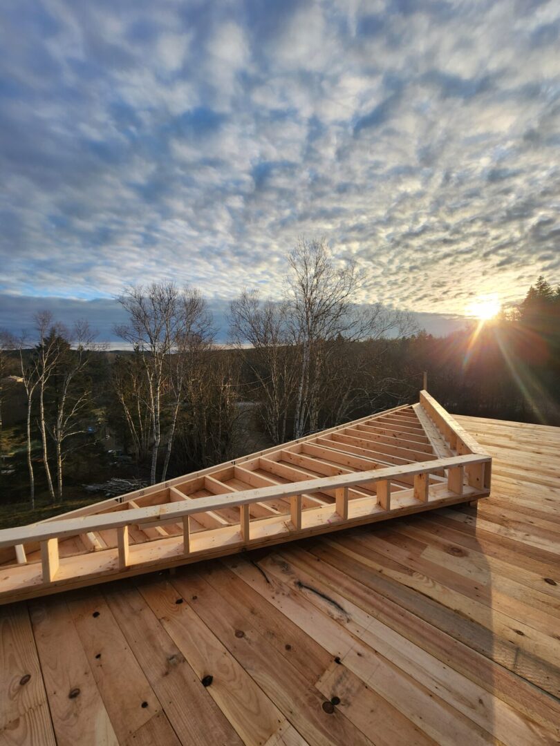 A wooden deck with steps leading to the top.