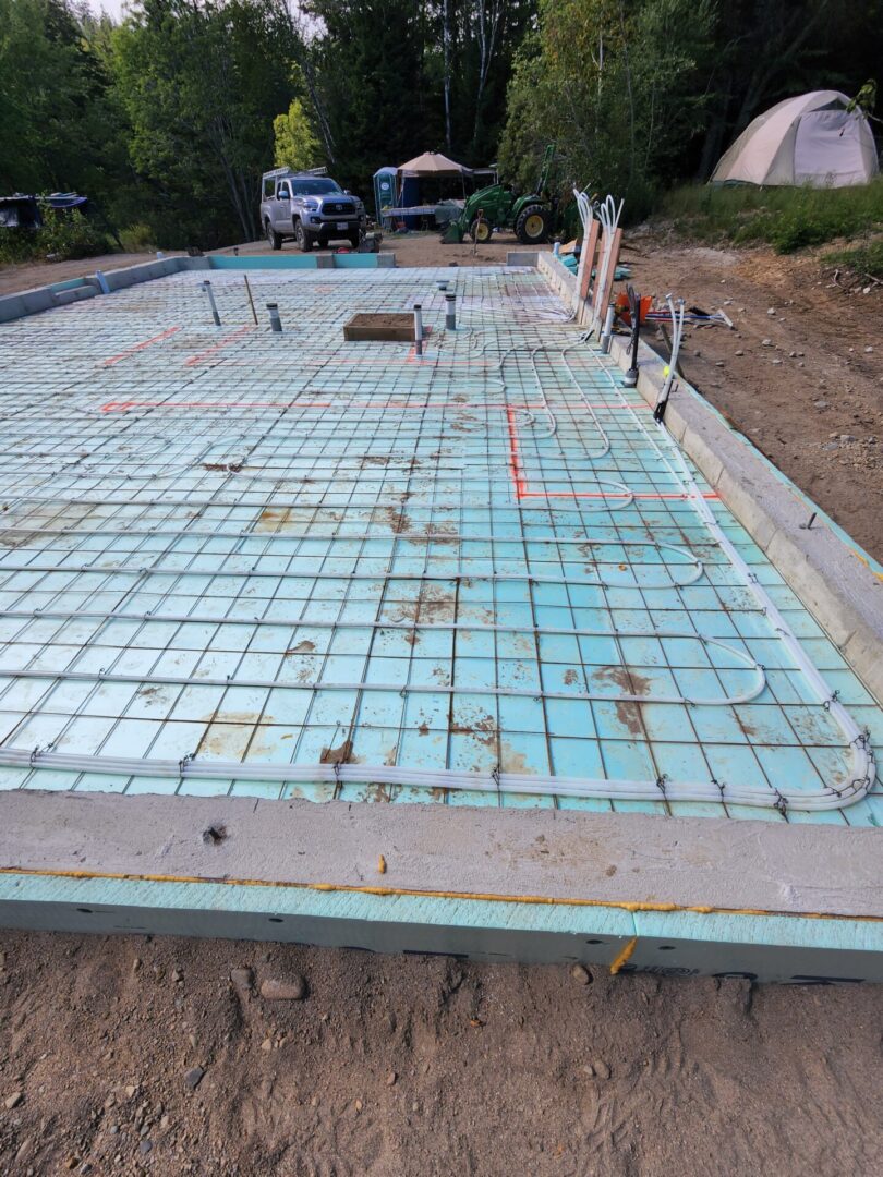 A concrete slab being poured for the foundation of a house.