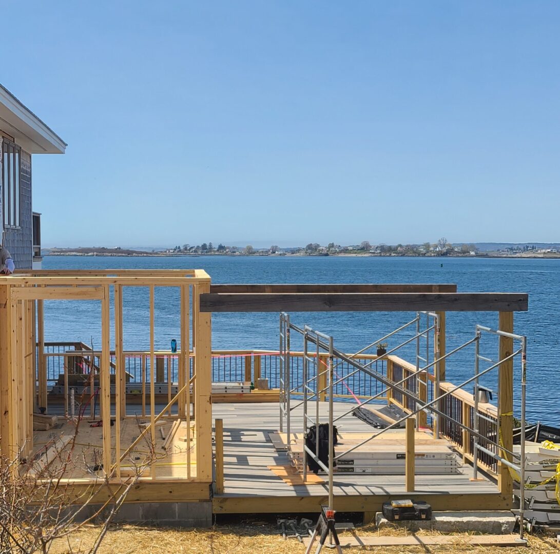 A wooden deck with a view of the ocean.