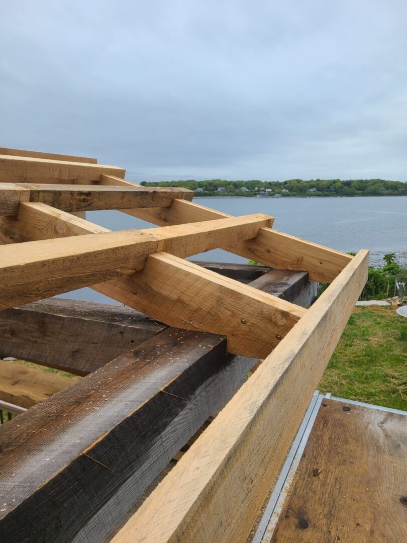 A wooden structure that is being built on the ground.