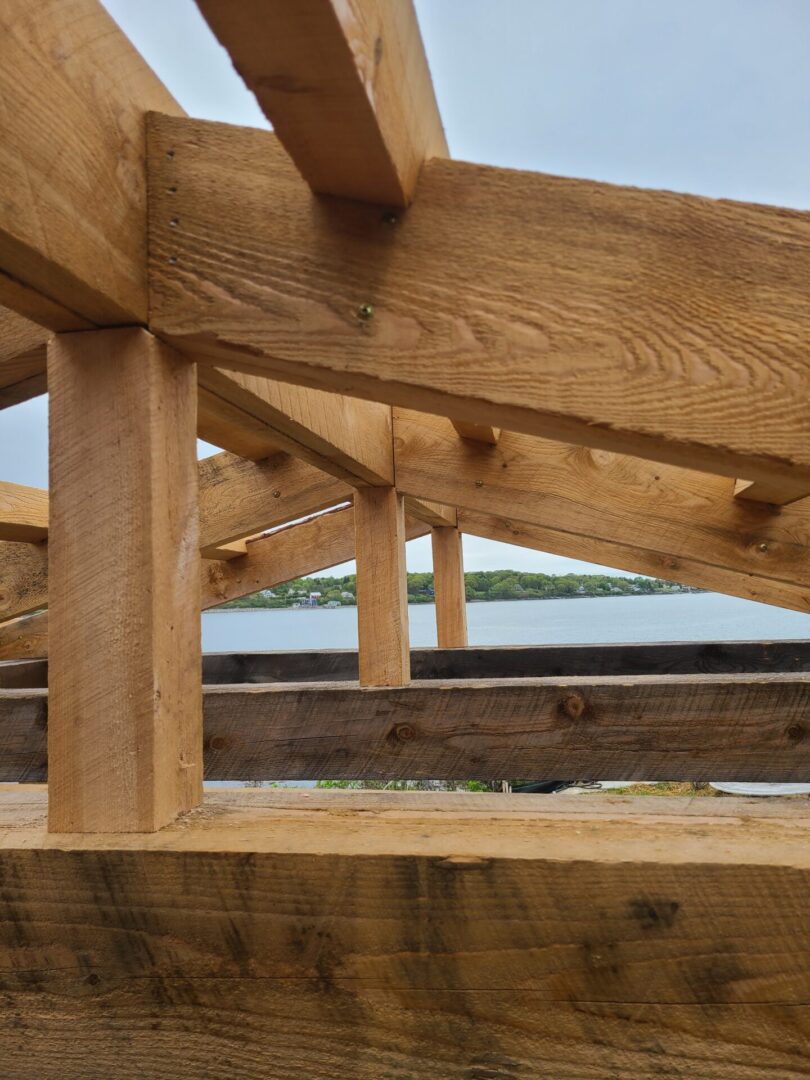 A wooden structure with a lake in the background.